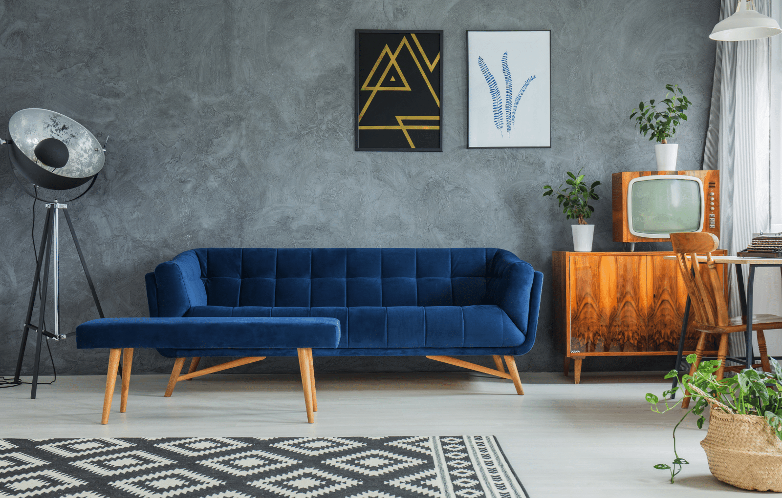 Living room with blue couch, art, and vintage decor